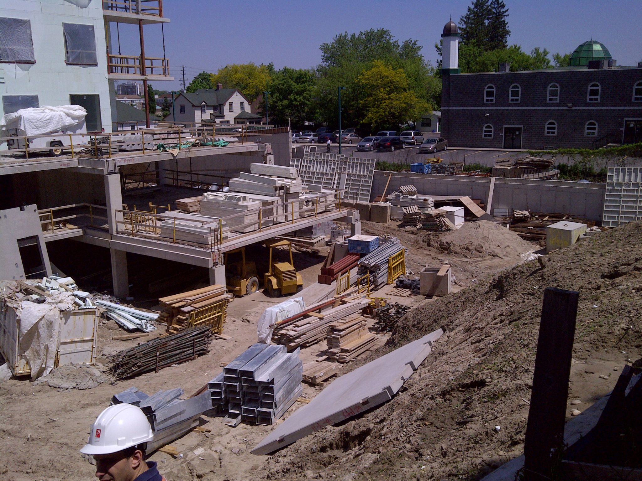 Early Jackman construction site with building frame and materials on site