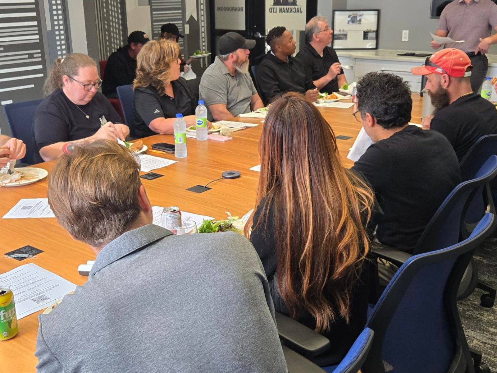 Jackman team gathered around a conference table for a lunch-and-learn