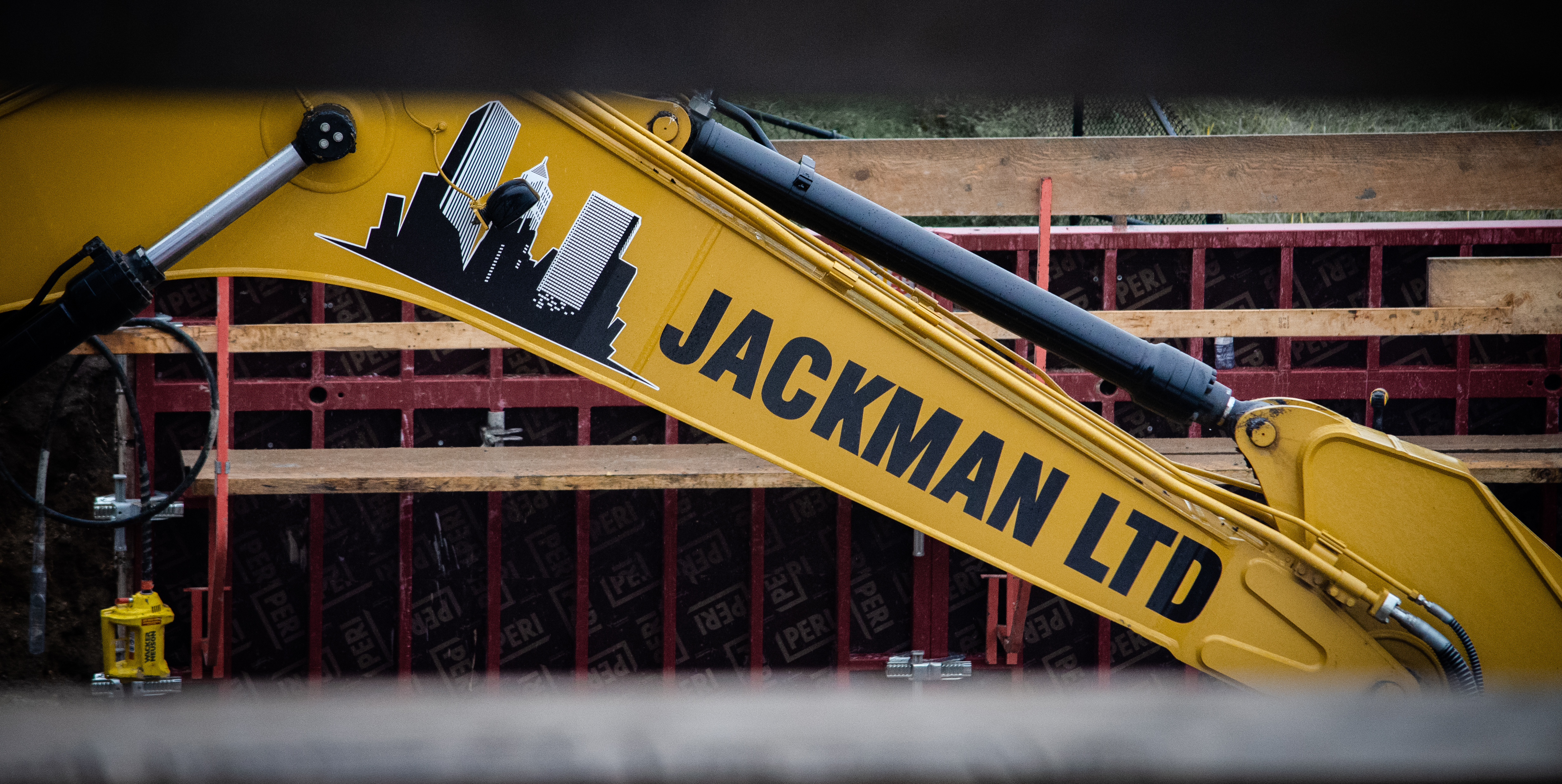 Jackman Ltd. excavator on site with company branding