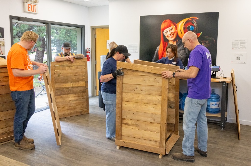 Jackman team members building wooden storage units during a Habitat for Humanity Waterloo Region engagement day