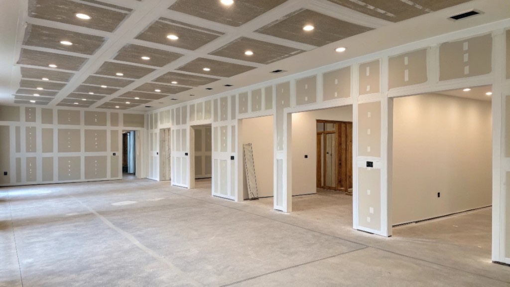 Commercial interior with taped drywall walls and coffered ceiling